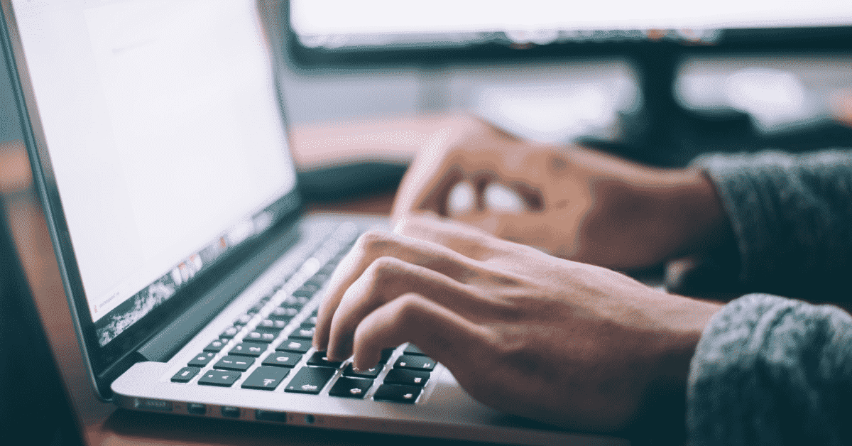 hands on laptop keyboard