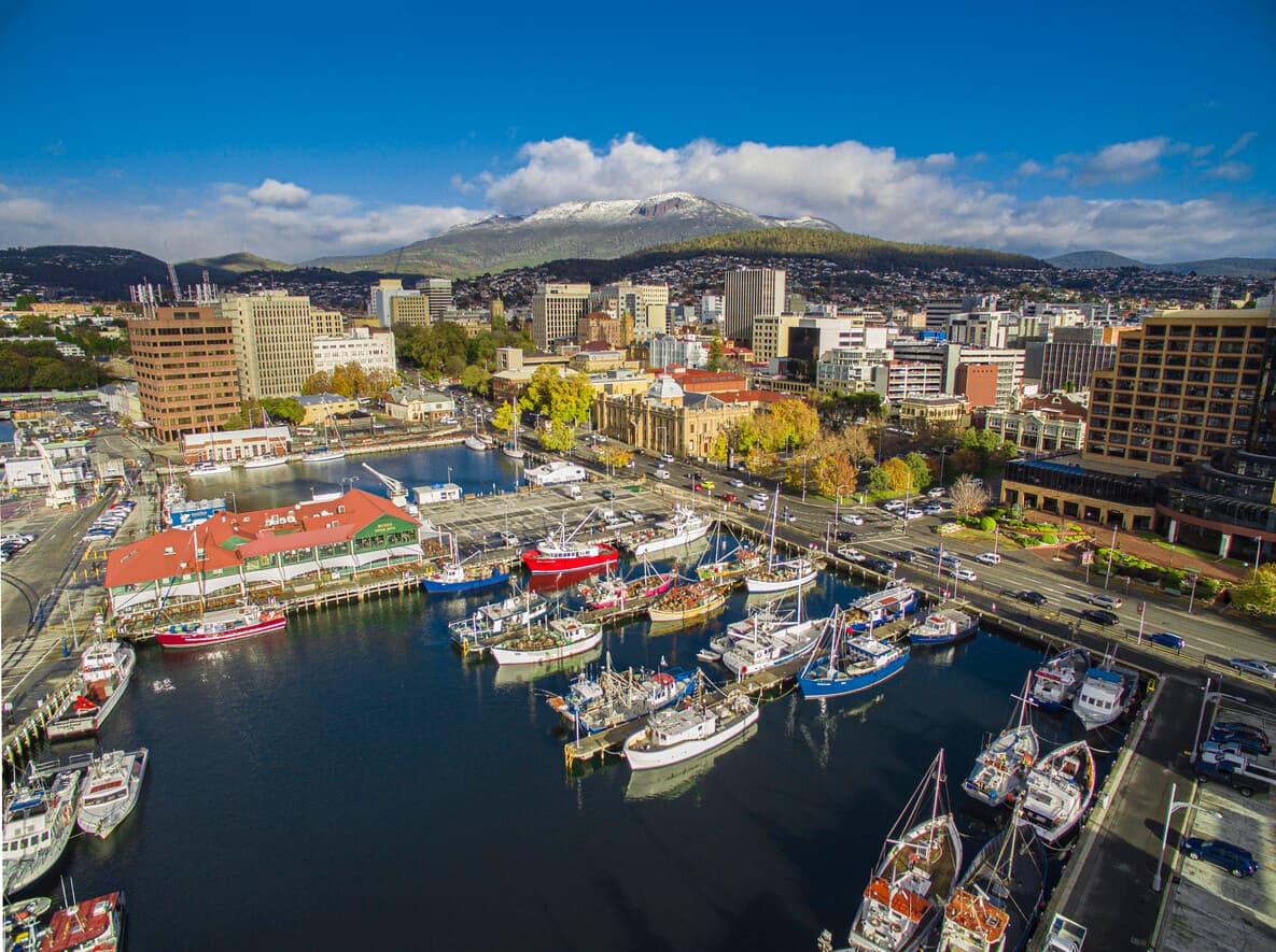 Aerial view of Hobart waterfront in Tasmania, showcasing the vibrant cityscape, harbour, and Mount Wellington in the background, relevant for those aspiring to become a buyer's agent in TAS